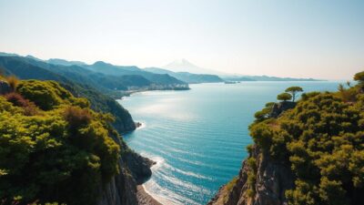 A breathtaking landscape of Osaka Bay, nestled between the majestic Rokko Mountains. In the foreground, a serene coastline with lush, verdant foliage cascading down the rugged cliffs. The middle ground showcases the sparkling azure waters of the bay, reflecting the warm, golden sunlight. In the distance, the iconic silhouette of Mount Rokko rises majestically, its peaks capped with a dusting of snow. The scene is bathed in a soft, diffused light, creating a sense of tranquility and natural harmony. A wide-angle lens captures the grandeur of the vista, inviting the viewer to immerse themselves in this picturesque Japanese haven.
